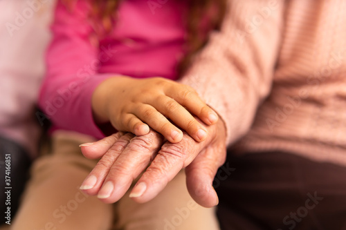 close up detail of young child and grandmother over each otherfamily, aging, care, support, unity concept.