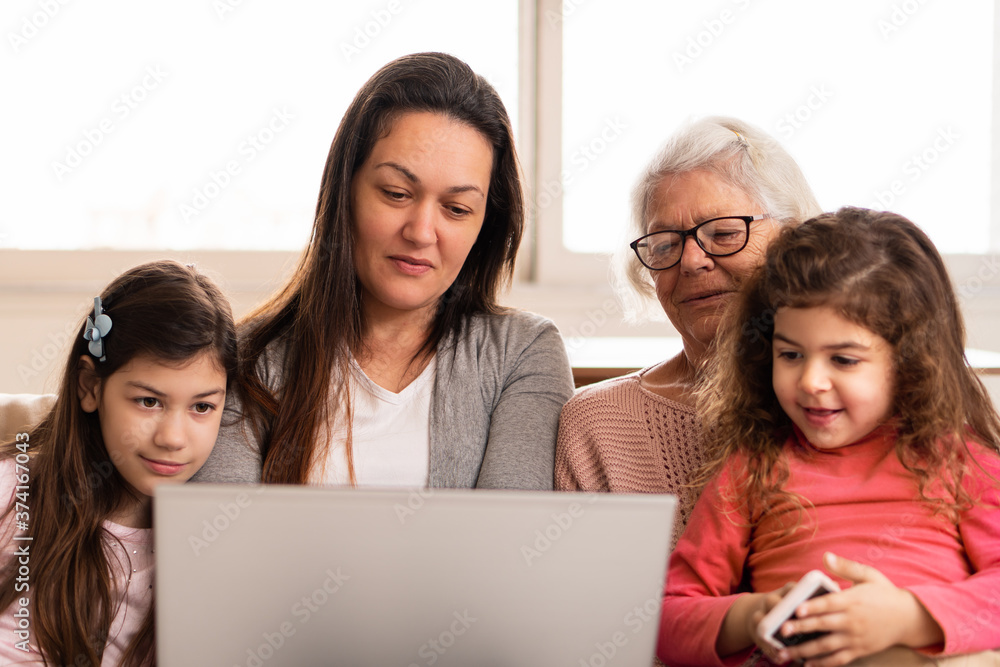Lovely multigenerational family with laptop spending time together Indoors at home living room. Unity, happiness, affection, love, care concept. Lovely multigenerational family with laptop spending time together Indoors at home living room. Unity, happiness, affection, love, care concept.