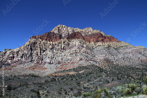 red rock layered rock mountain in desert