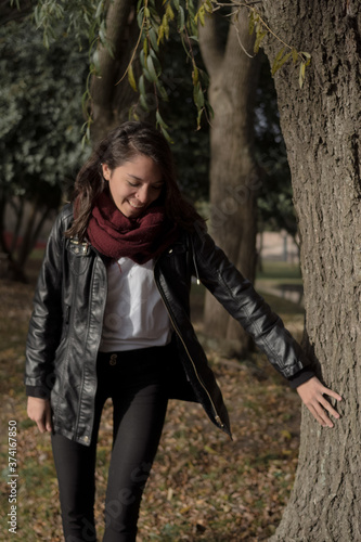 girl smiling touching a tree, positive concept environmental campaign natural advertising