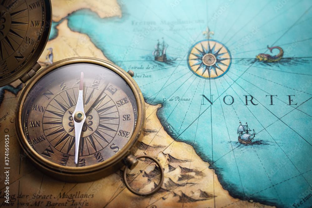 Foto Stock Magnetic old compass on world map.Travel, geography, navigation,  tourism and exploration concept background. Treasure Island on the Pirate  Map. | Adobe Stock