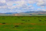 Mongolia steppe landscape of infinite grasslands under beautiful cloud in blue sly