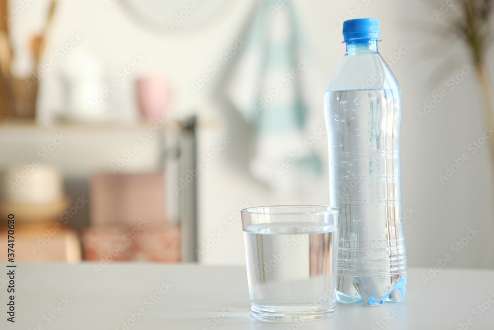 Clear water in a glass and bottle on the table Clear water in a glass and bottle on the table
