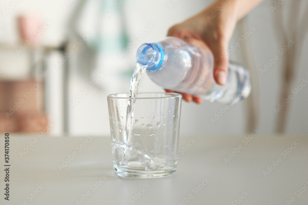 Clear water in a glass and bottle on the table Clear water in a glass and bottle on the table