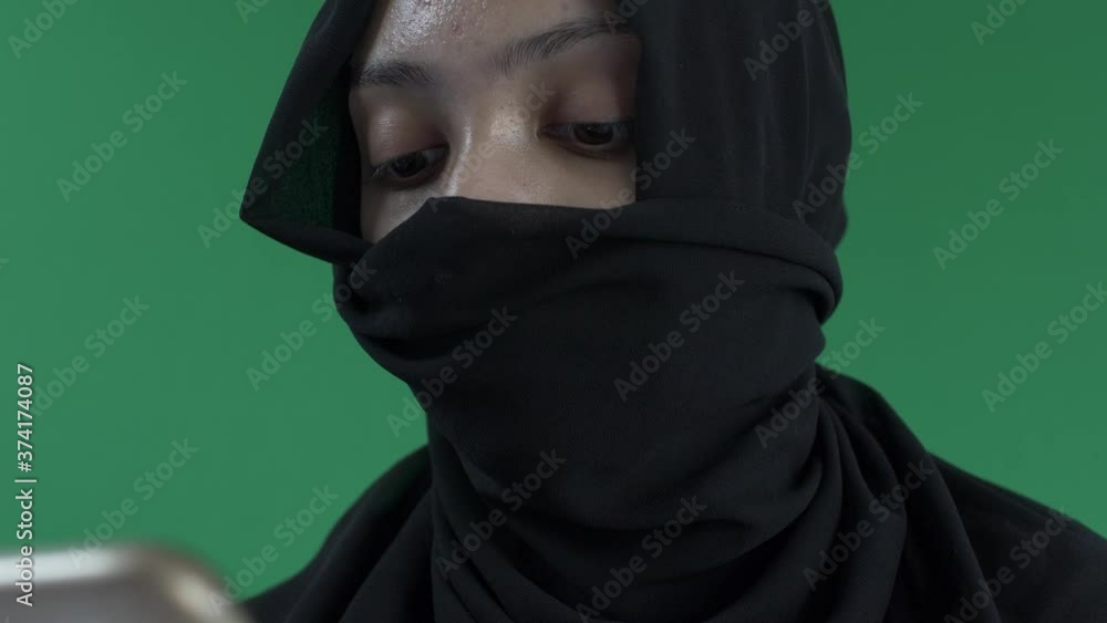 Young Hijab Muslim Woman Texting On Mobile Phone. Close Up, Green Screen Young Hijab Muslim Woman Texting On Mobile Phone. Close Up, Green Screen