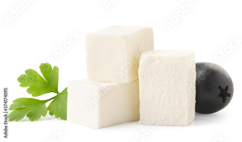Cubes of feta cheese with a leaf and an olive close-up on a white. Isolated