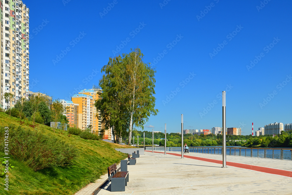 Naklejka premium Embankment and new modern residential district of Pavshinsky floodplain on Moscow River bank in summer sunny day
