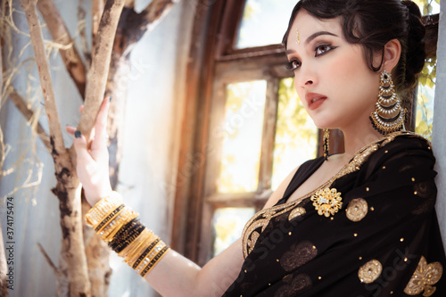 Portrait of young asian girl with kundan jewelry set and traditional hindu Indian costume saree and lehenga dress model photo