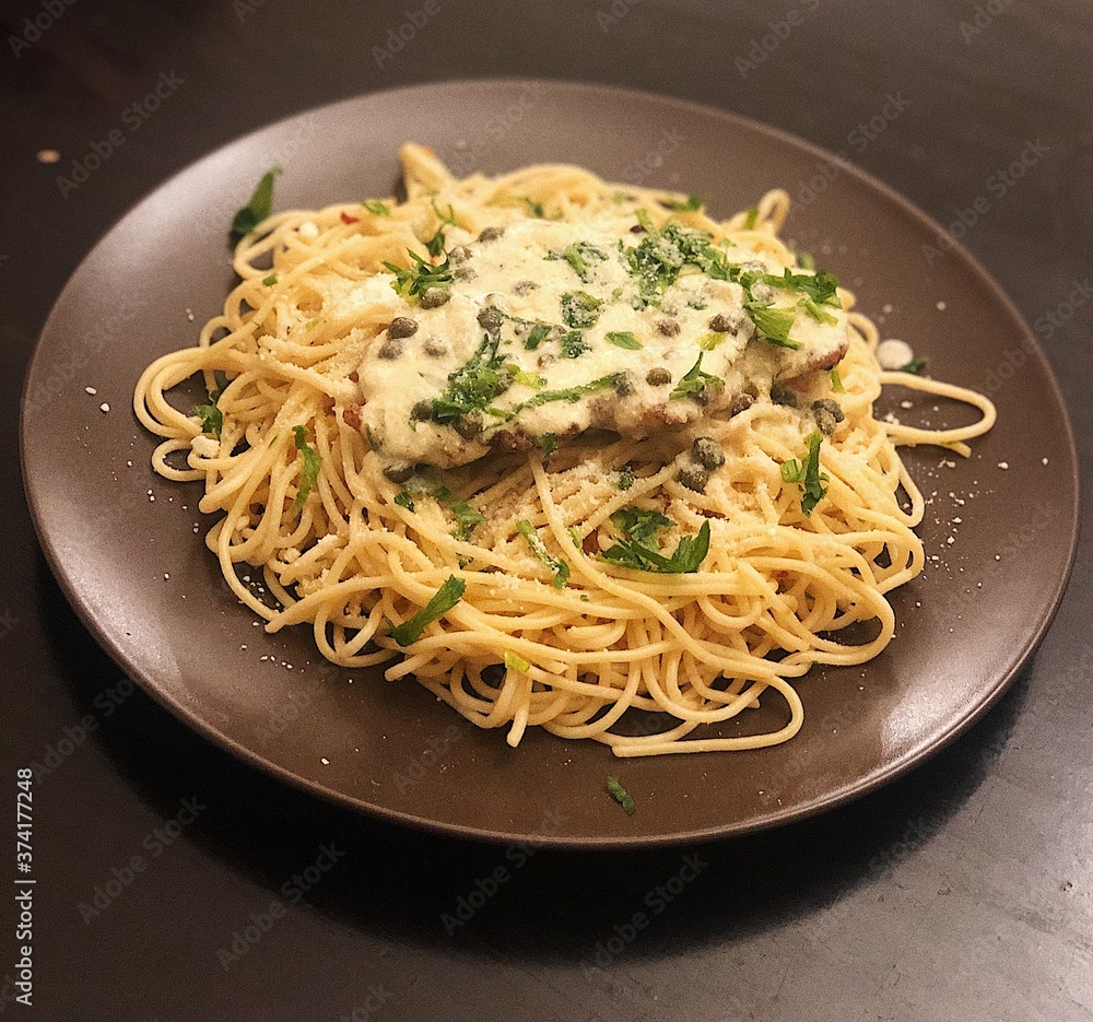Chicken piccatta with spaghetti and lemon capers