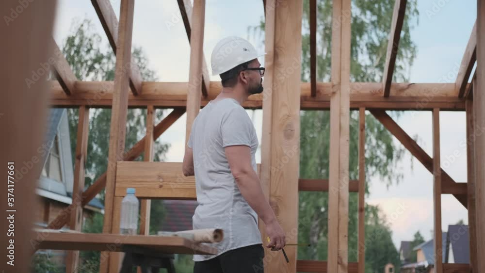 A man walks along the scaffolding of the future house A man walks along the scaffolding of the future house