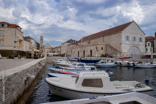Hvar/Croatia-August 5th,2020: Old, historical buildings in the town of Hvar, old navy Arsenal building and the St. Stephen cathedral in the background