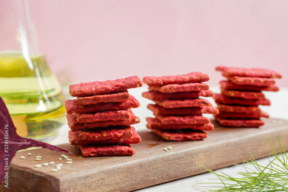 Natural crackers or beetroot cookies on a light background. Healthy food concept for wellness. Diet foods. Natural crackers or beetroot cookies on a light background. Healthy food concept for wellness. Diet foods.