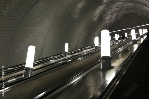 Escalator with lanterns while descending into the subway photo