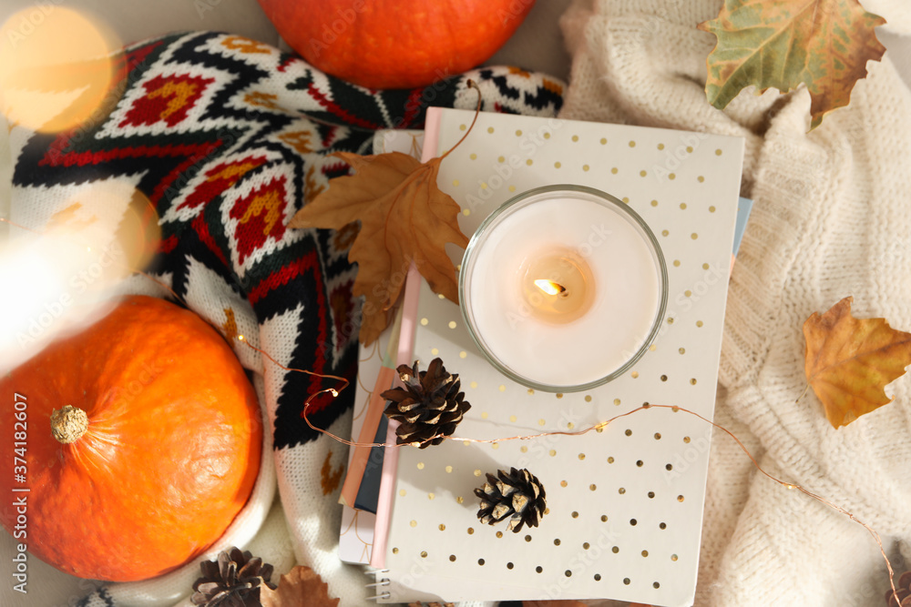 Autumn concept with candle, sweater and pumpkin, top view Autumn concept with candle, sweater and pumpkin, top view