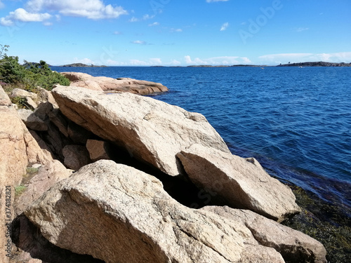 Beautiful shot of the sea taken from the beach of Gjeving, Norway with big rock formations photo