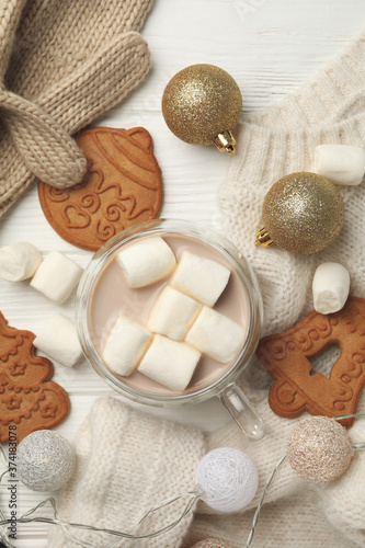 Winter concept with sweater, coffee with marshmallow and cookies on wooden background