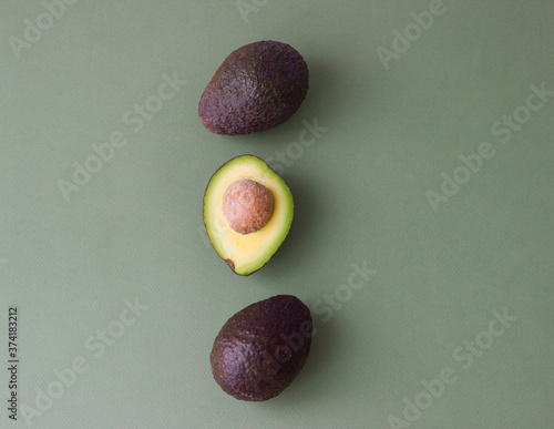 Fresh avocado on green background