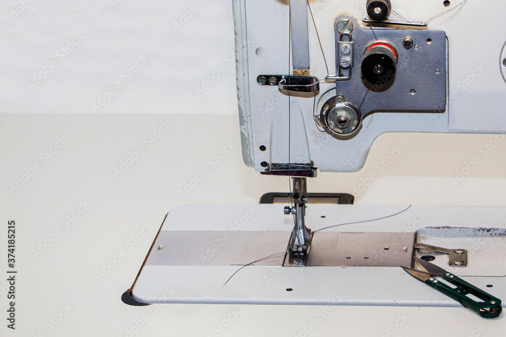 Industrial sewing machine. Clothing manufacturing, tailoring. Close up.