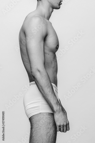 Human's torso in profile. Isolated vertical black-and-white image.