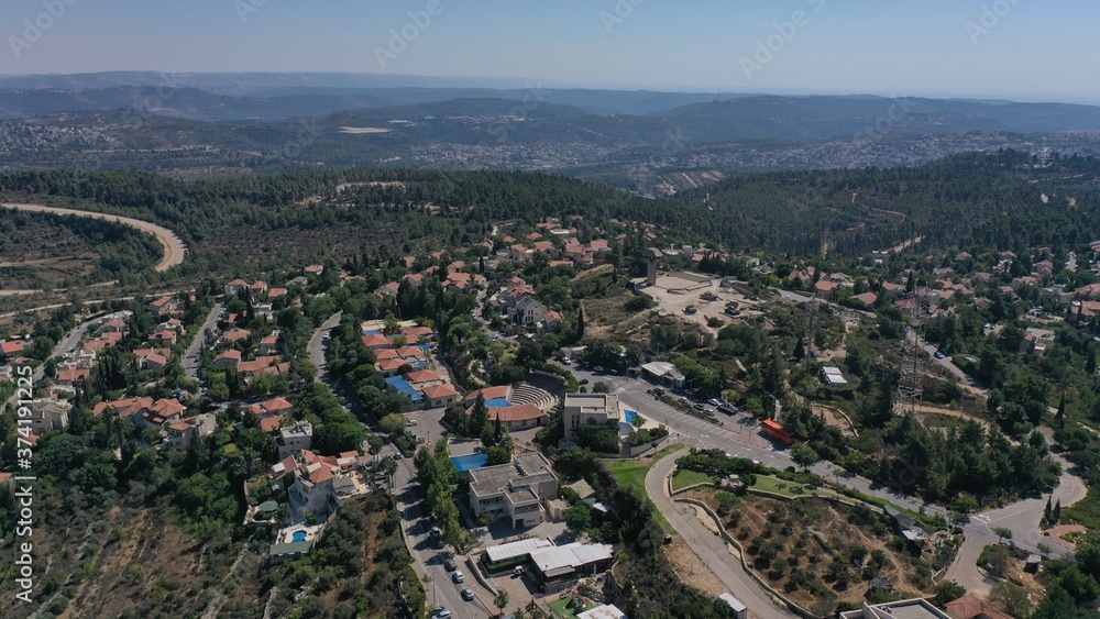 Small town with red rooftops Close to the Mountains Aerial view
Drone, Har adar,August,2020,Israel
