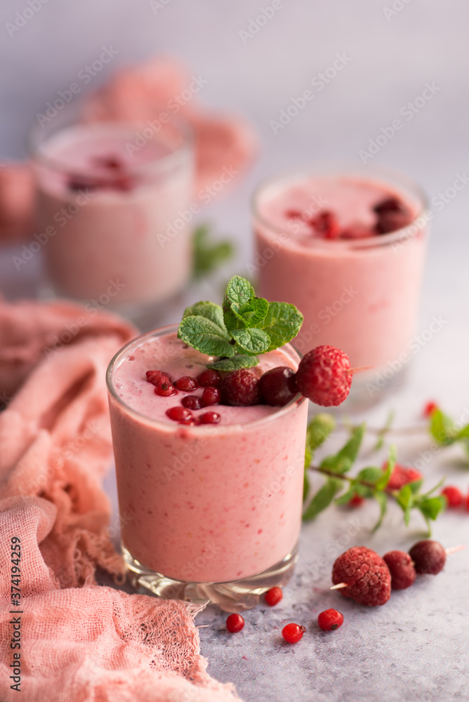 Glasses of berry smoothie with fresh mint on dark background. Glasses of berry smoothie with fresh mint on dark background.
