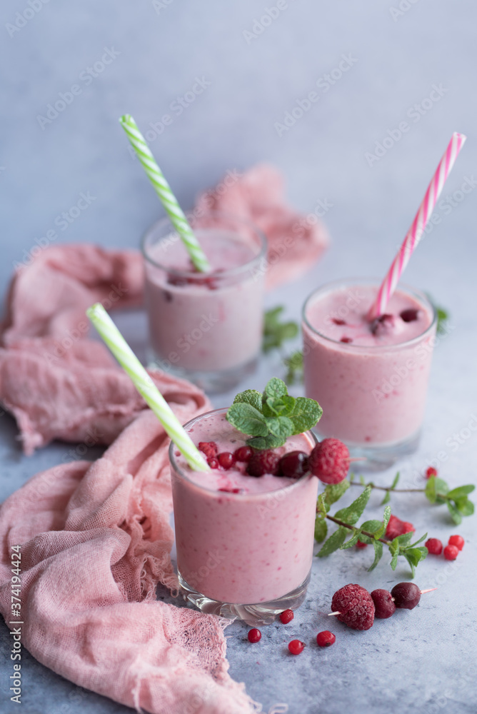 Glasses of berry smoothie on light background. Glasses of berry smoothie on light background.
