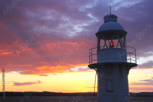 Lighthouse against beautiful sunset sky