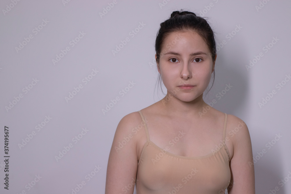emotional portrait of attractive brunette, actress in a beige undershirt - bodysuit on white background. space for text. High quality photo emotional portrait of attractive brunette, actress in a beige undershirt - bodysuit on white background. space for text. High quality photo