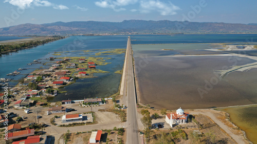 Aerial drone photo of artificial sea salt ponds in area Tourlida of Kleisova lagoon featuring seaside traditional settlement, Mesolongi, Aitoloakarnania, Greece photo