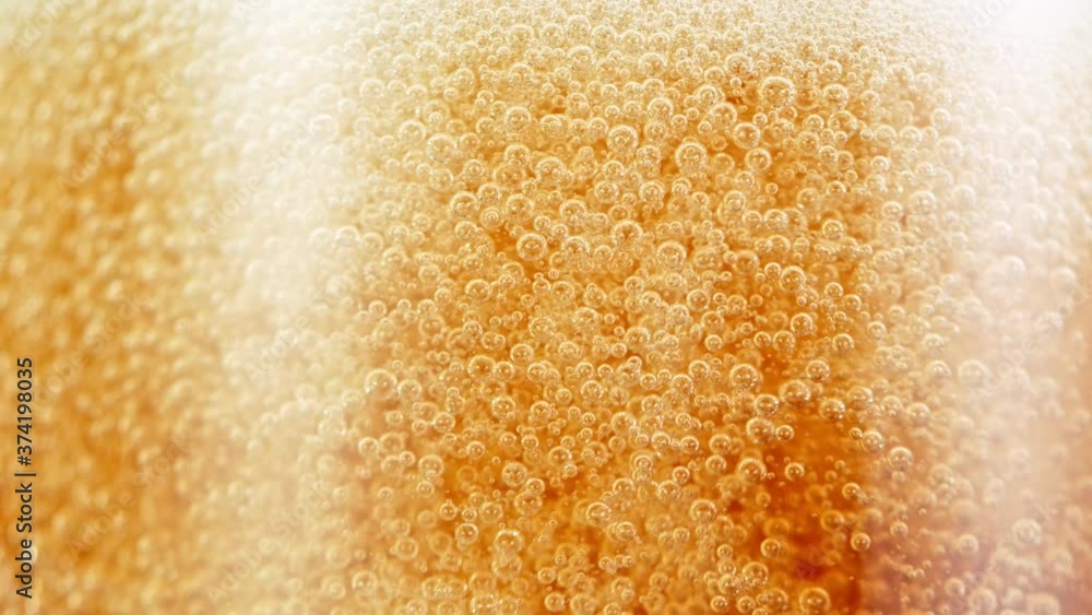 Macro Shot Of Bubbles Rising In A Glass With Beer, Super Slow Motion at 1000 fps. Macro Shot Of Bubbles Rising In A Glass With Beer, Super Slow Motion at 1000 fps.
