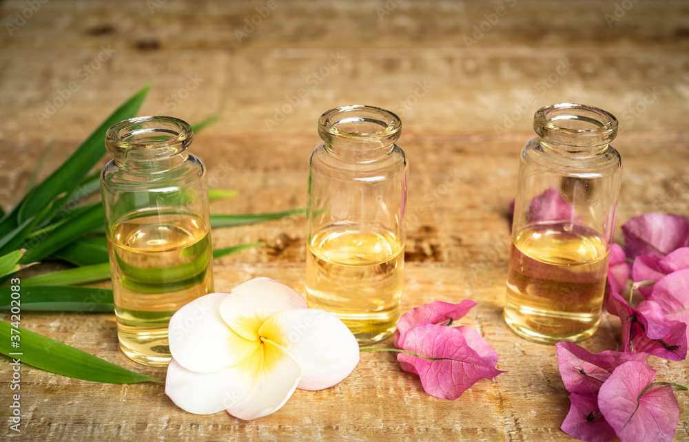 Essential oil in small glass bottles with bamboo leaves, bougainvillea and frangipani flowers on wooden background. Selective focus. top view and copy space for text. Natural cosmetics.
Essential oil in small glass bottles with bamboo leaves, bougainvillea and frangipani flowers on wooden background. Selective focus. top view and copy space for text. Natural cosmetics.
