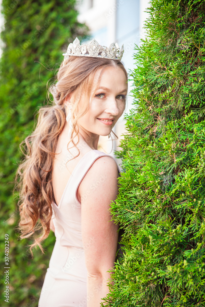 Naklejka premium Queen. Bohemian woman wearing a crown. Attractive long-haired brunette with jewelry on her head. Rich and luxurious life.