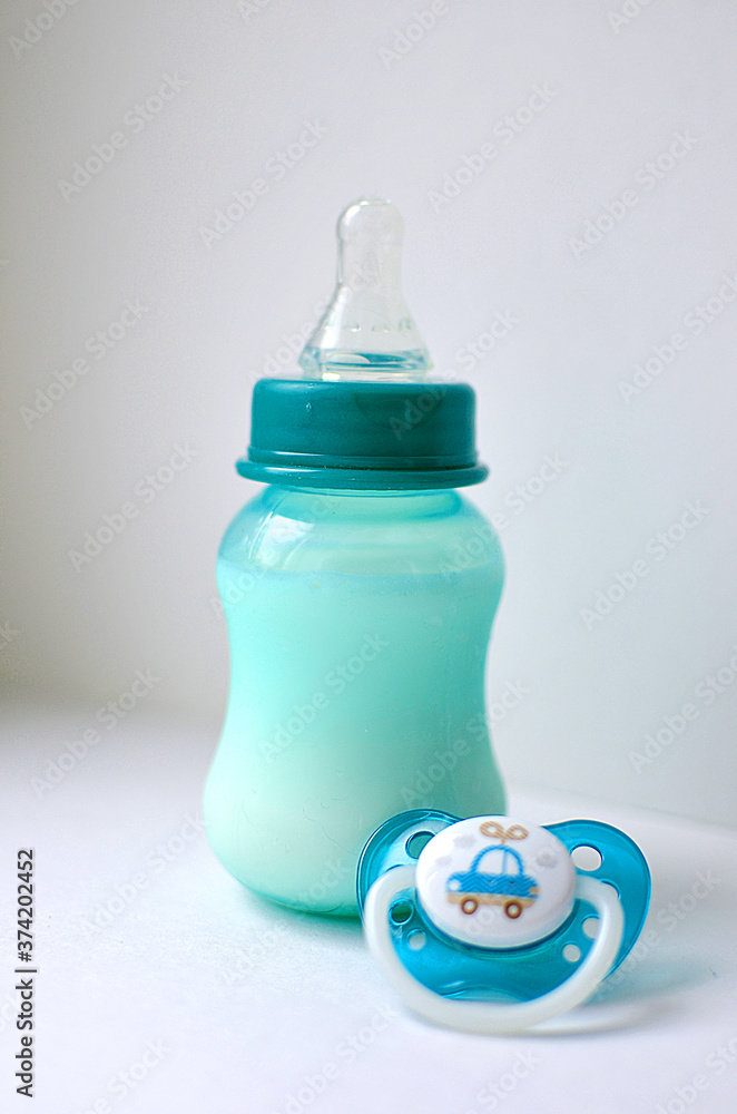 Photo of a baby bottle with breast milk. The concept of a happy childhood and motherhood. Photo on a white background. Support for breastfeeding. Photo of a baby bottle with breast milk. The concept of a happy childhood and motherhood. Photo on a white background. Support for breastfeeding.