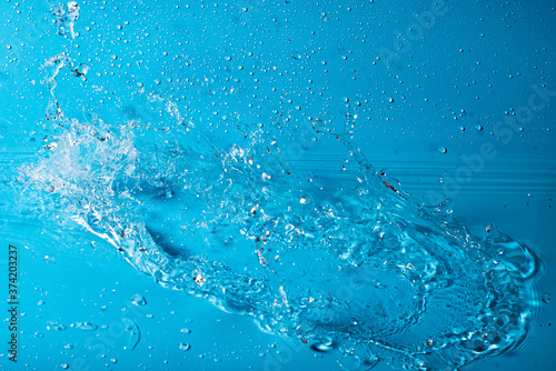splash of water on a blue background. Abstract wallpaper