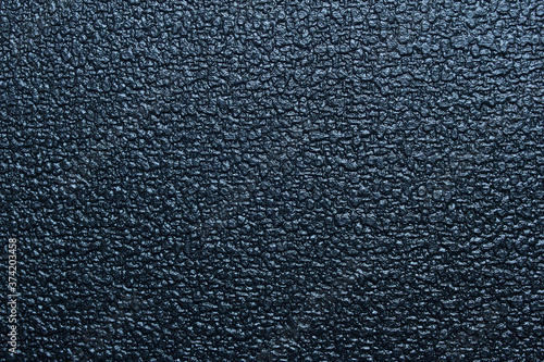 Shiny black background with plasticized texture with relief and strange shapes. Abstract landscape.