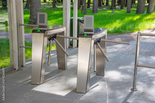 Steel automatic turnstile with arrows for access to the public park