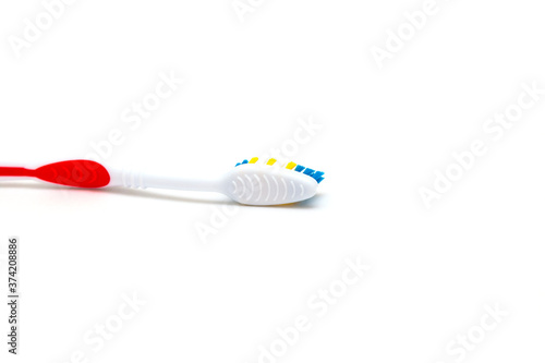 The toothbrush lies on a white background. Brushing your teeth to keep them healthy