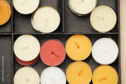 top view of colored candles in a box. flat lay