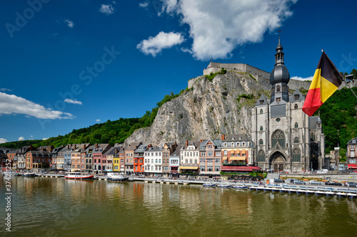 View of picturesque Dinant town, Dinant Citadel and Collegiate Church of Notre Dame de Dinant over the Meuse river with belgium flag. Belgian province of Namur, Blegium photo