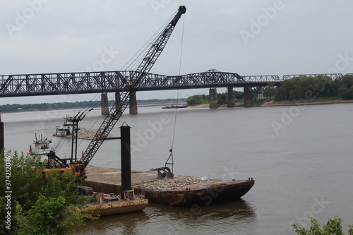 crane near arkansas bridge along mississippi river