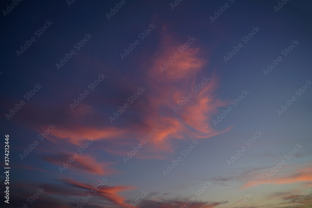 Atmospheric fantastic pink clouds in gradations of blue in the sunset sky