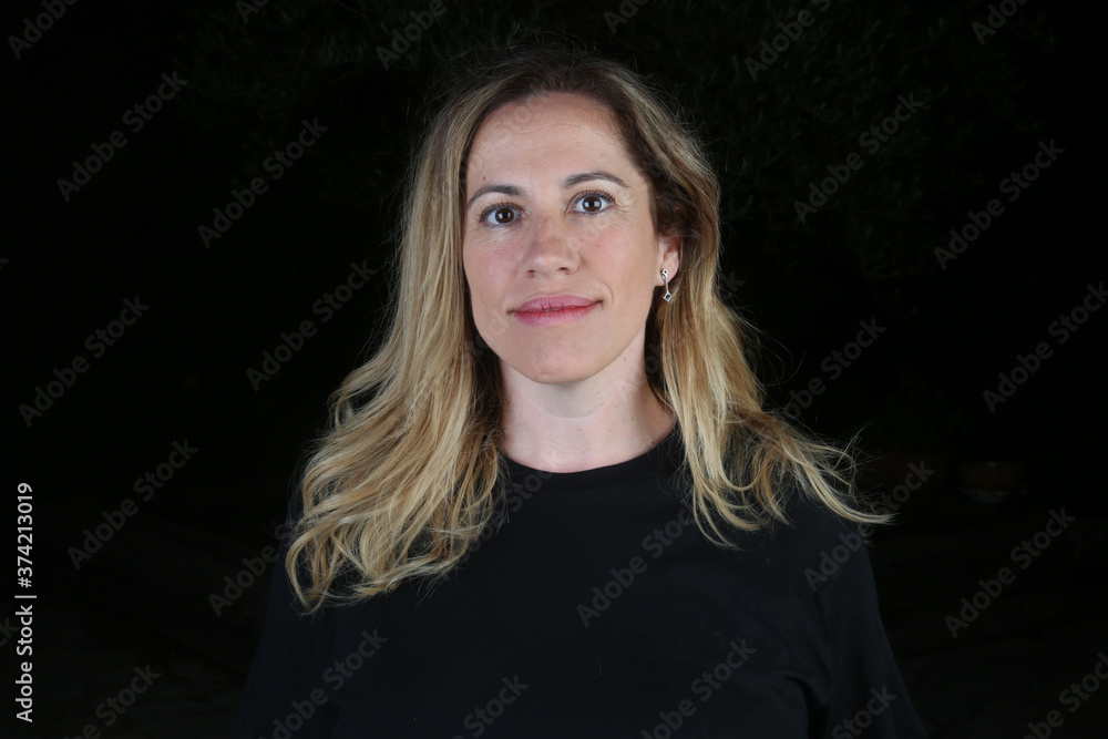 blond woman studio portrait with black background blond woman studio portrait with black background