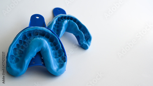 Close up of a dentist dental technique bite 3D impression teeth - molding trays - upper and lower jaw. photo