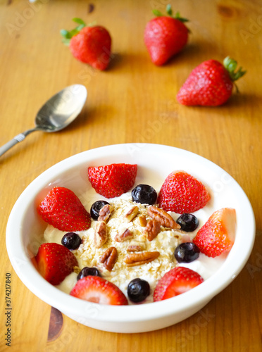 Strawberry yoghurt parfait on wooden table 