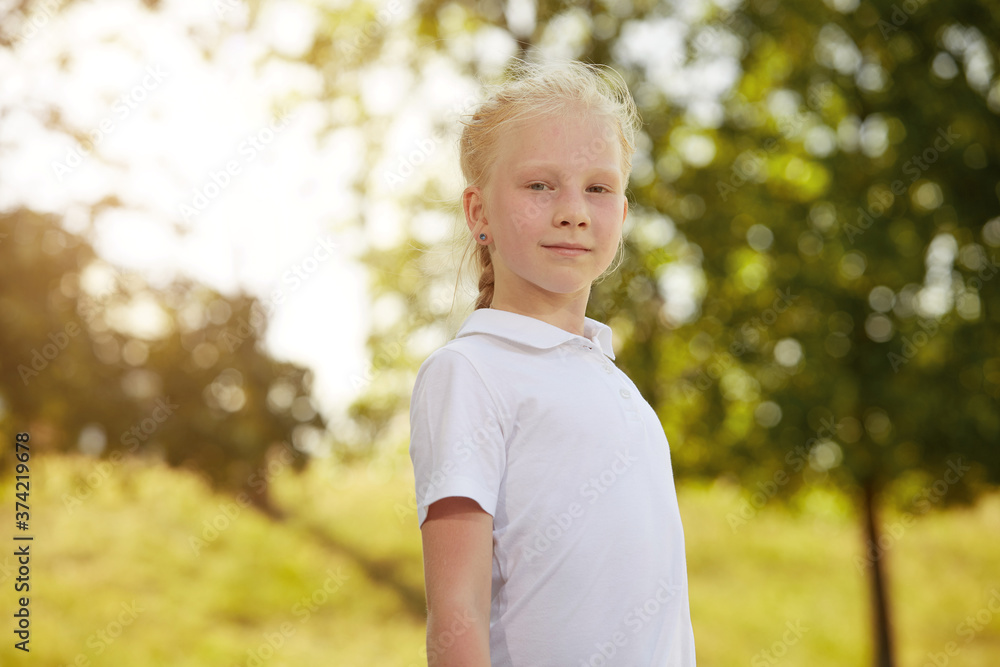 Portrait of a little girl in a white t-shirt in the Park Sunny day Portrait of a little girl in a white t-shirt in the Park Sunny day
