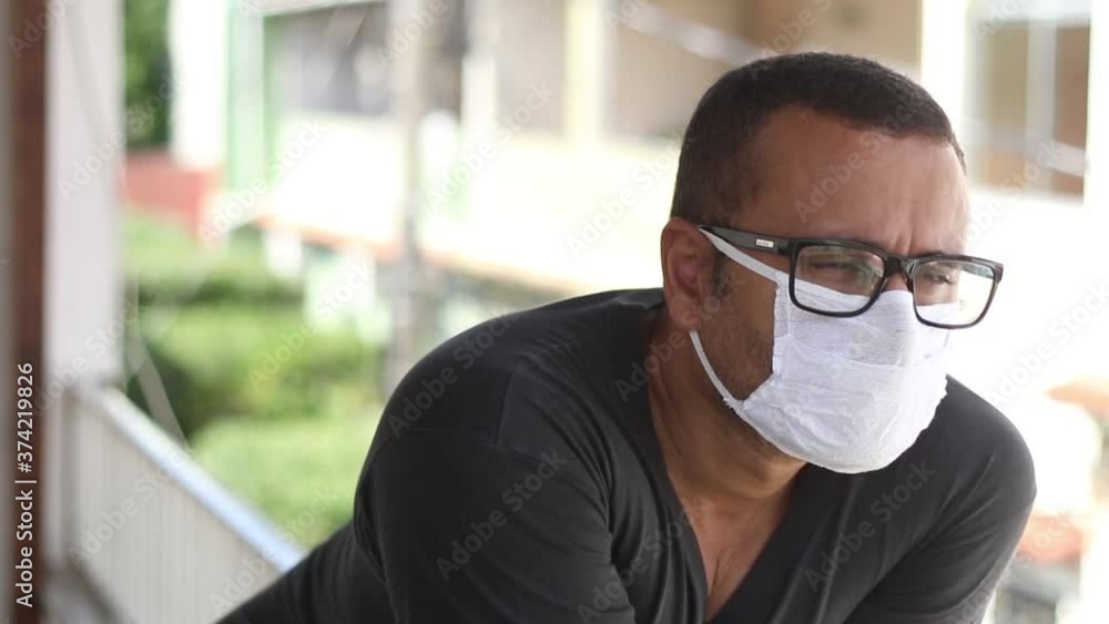 Sick brazilian man wearing medical mask at home during Coronavirus outbreak Sick brazilian man wearing medical mask at home during Coronavirus outbreak