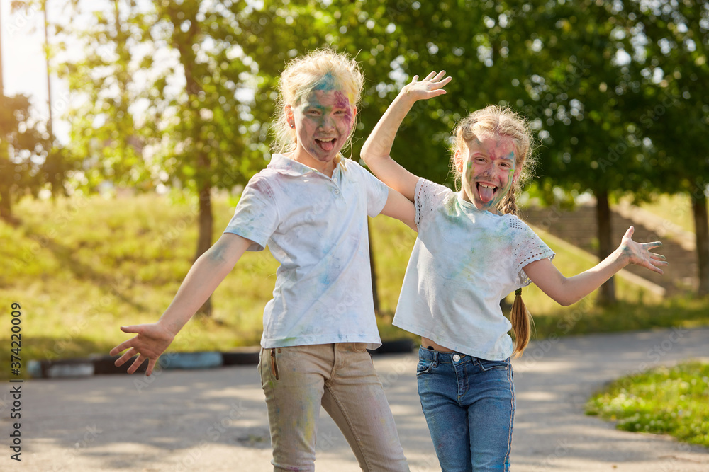 Fototapeta premium Two sisters pose for the camera outdoors in a Sunny Park. Selective focus