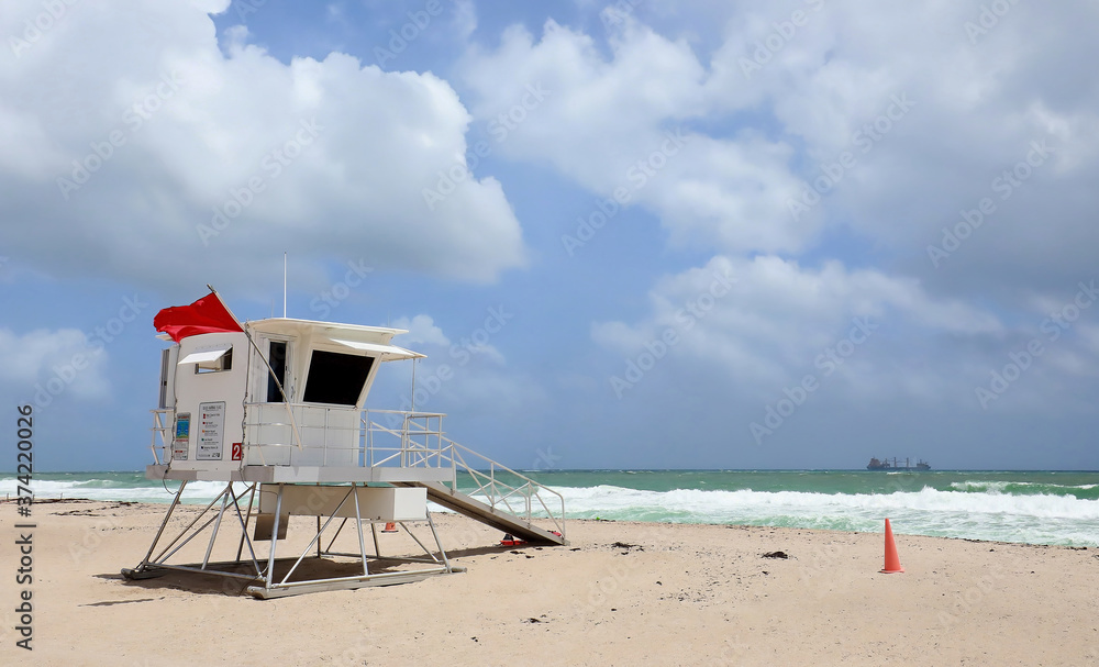 Lifeguard tower on Fort Lauderdale Beach flies a red flag indicating extremely dangerous surf during Tropical Storm Laura.