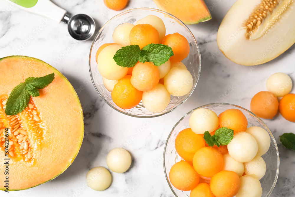Flat lay composition with melon balls and mint on white marble table Flat lay composition with melon balls and mint on white marble table