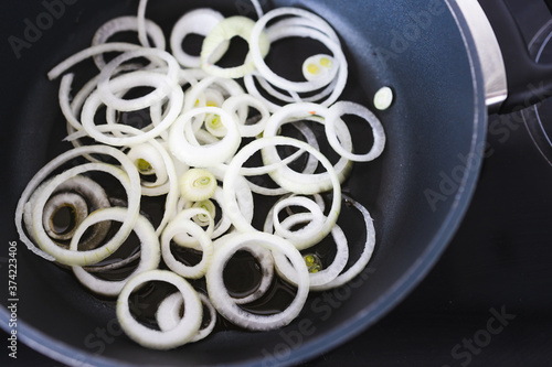 simple food ingredients, fresh caramelised onions cut into rings on pan